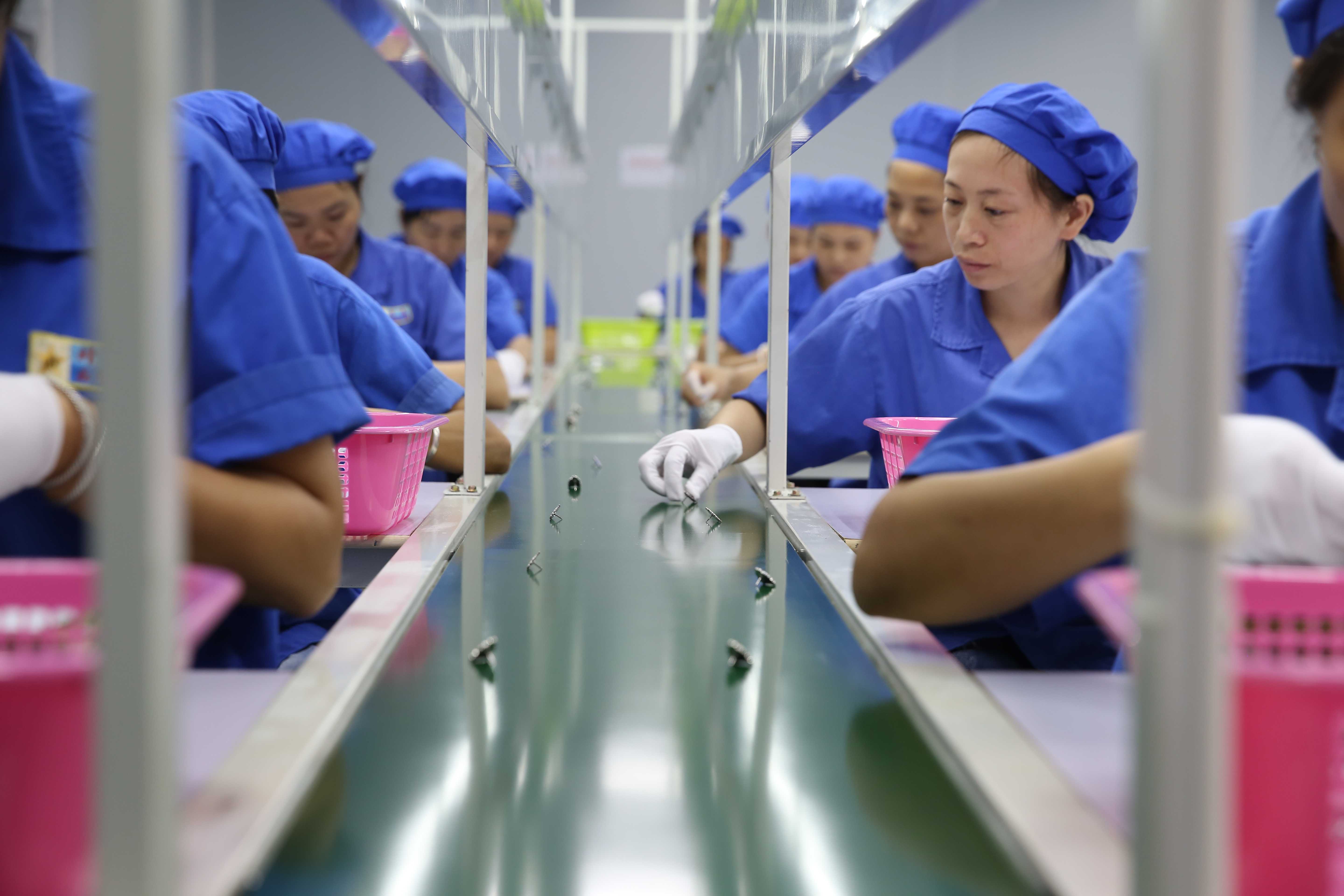 Happy gift QC workshop - Dongguan happy gift QC workshop showing quality inspectors conducting precision testing on gift products using advanced measurement tools in a bright inspection area.